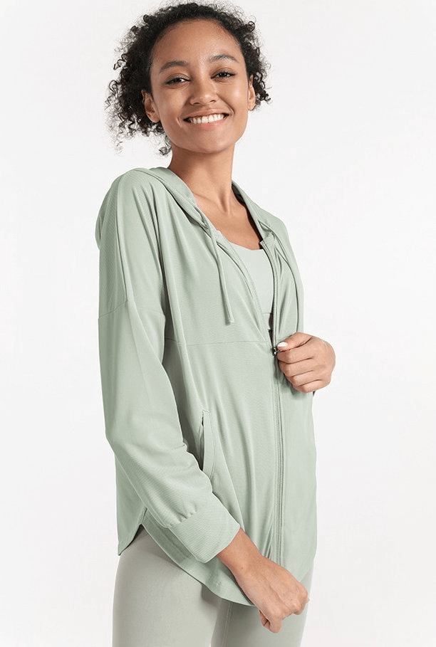 Woman wearing light green Quick Dry Loose Casual Training Hoodie with zipper, ideal for yoga and fitness.